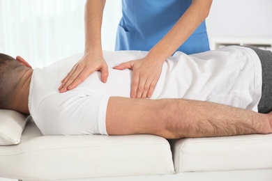 Photo of Doctor working with patient in hospital, closeup. Rehabilitation massage