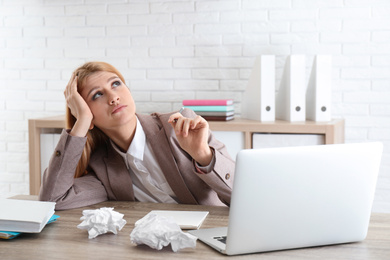 Lazy employee wasting time at table in office