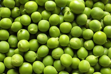 Many fresh green peas as background, top view