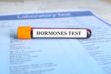 Photo of Hormones test. Sample tube with blood on laboratory form