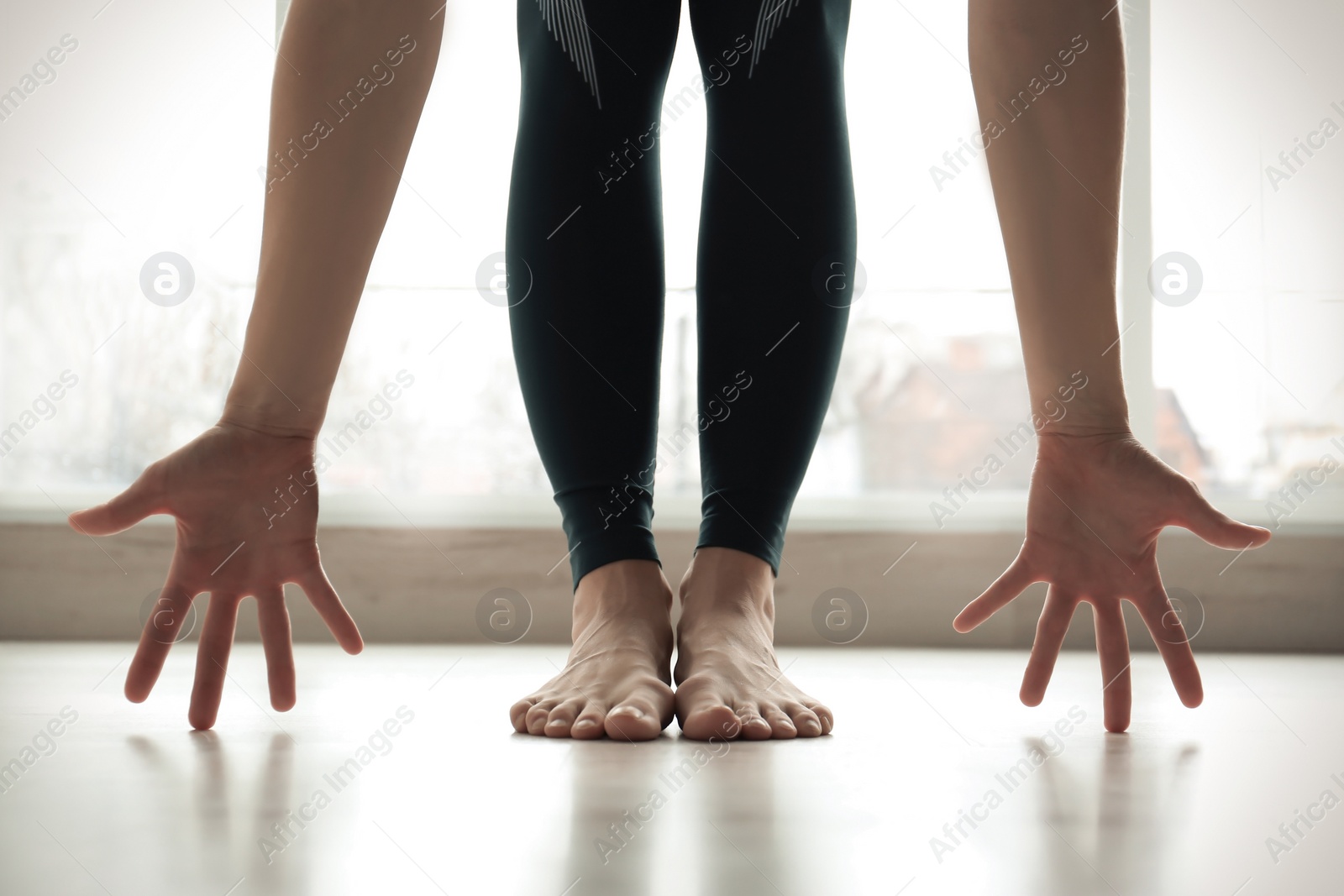 Photo of Young woman practicing yoga indoors, closeup