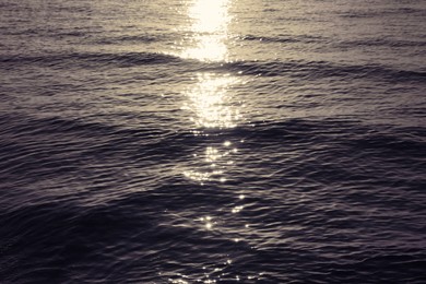 Rippled surface of sea at sunset as background