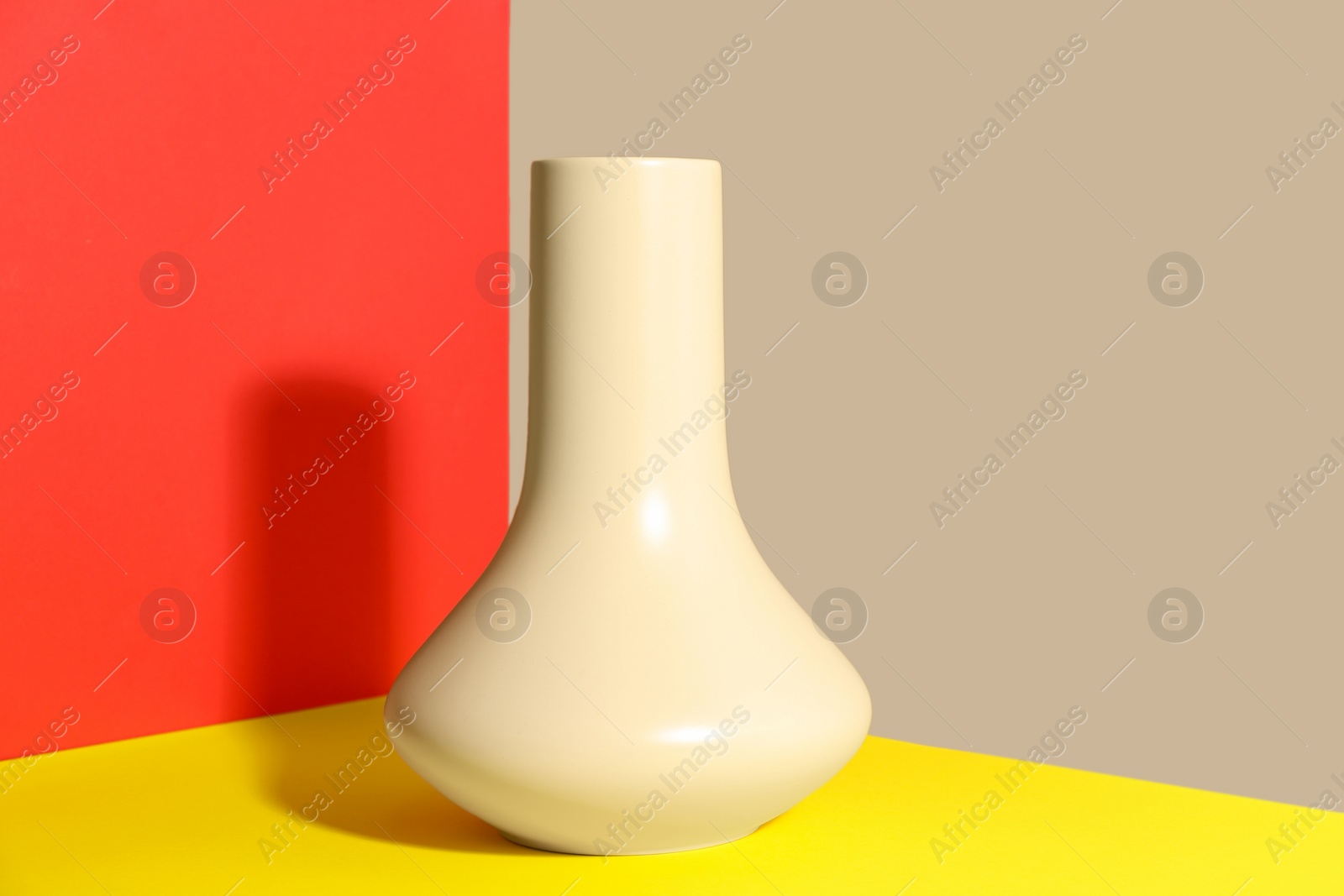 Photo of Stylish empty ceramic vase on color background