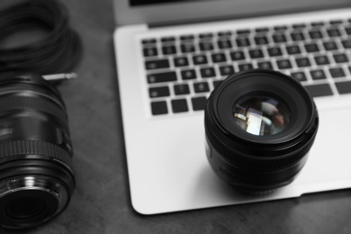 Photo of Professional photographer equipment and laptop on table