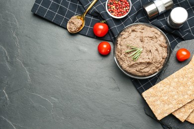 Flat lay composition with tasty liver pate on black table. Space for text