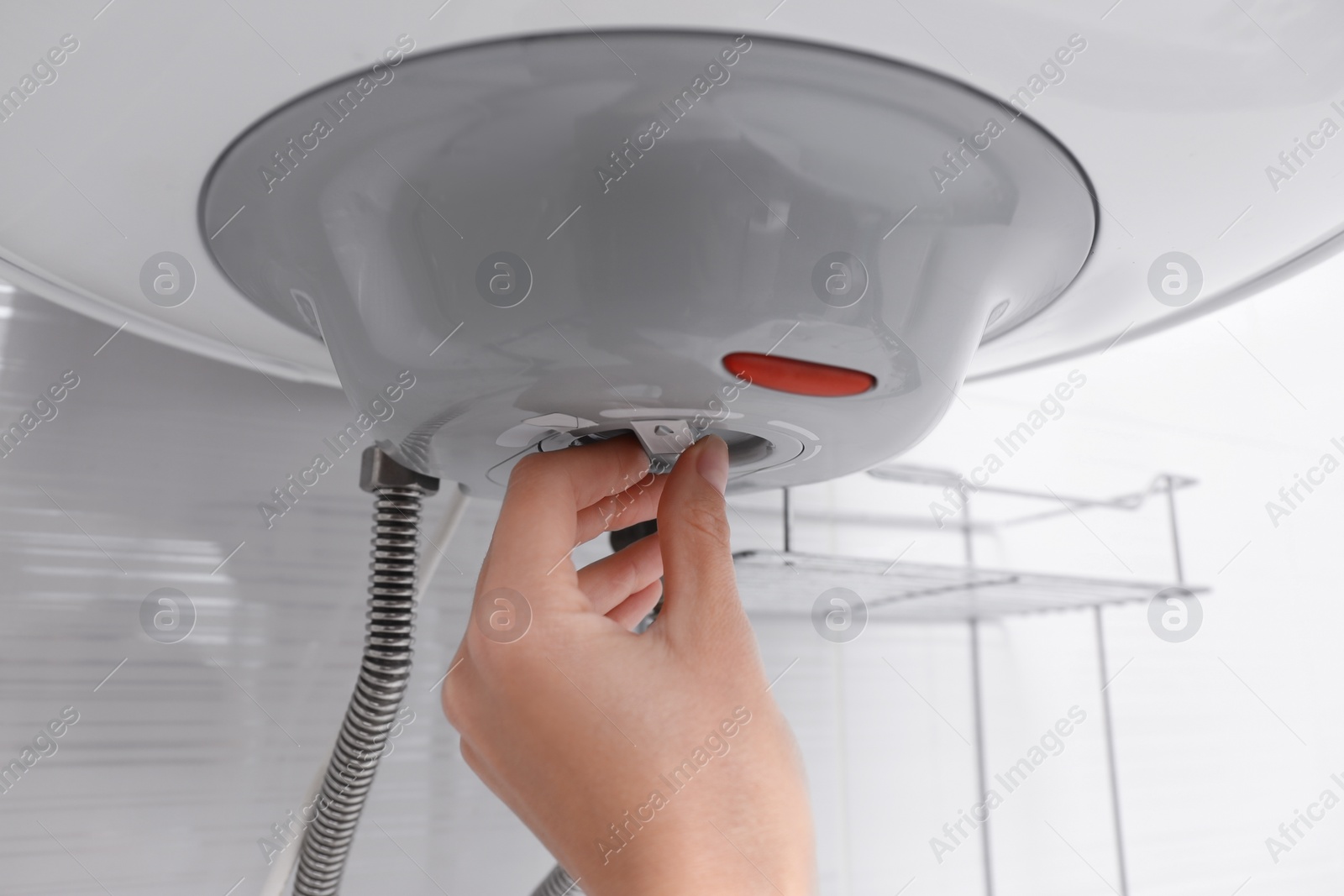 Photo of Woman adjusting maximum energy efficiency indicator indoors, closeup. Boiler installation