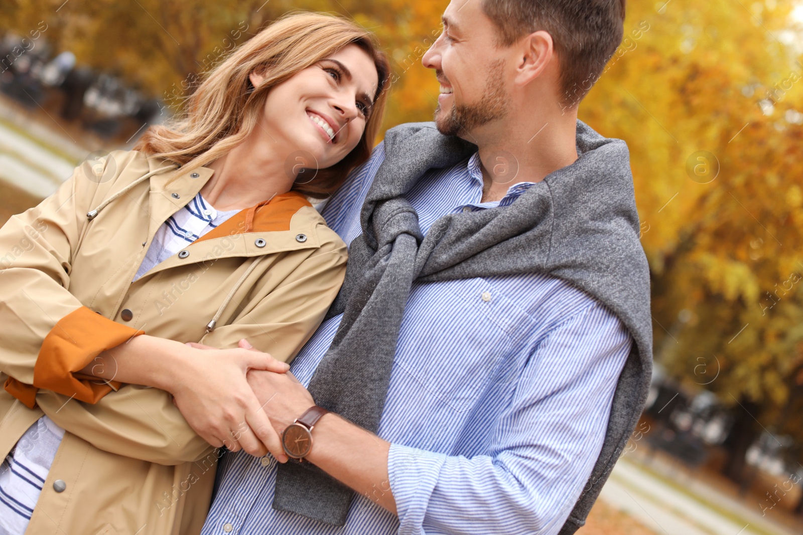 Photo of Lovely couple spending time together in park. Autumn walk