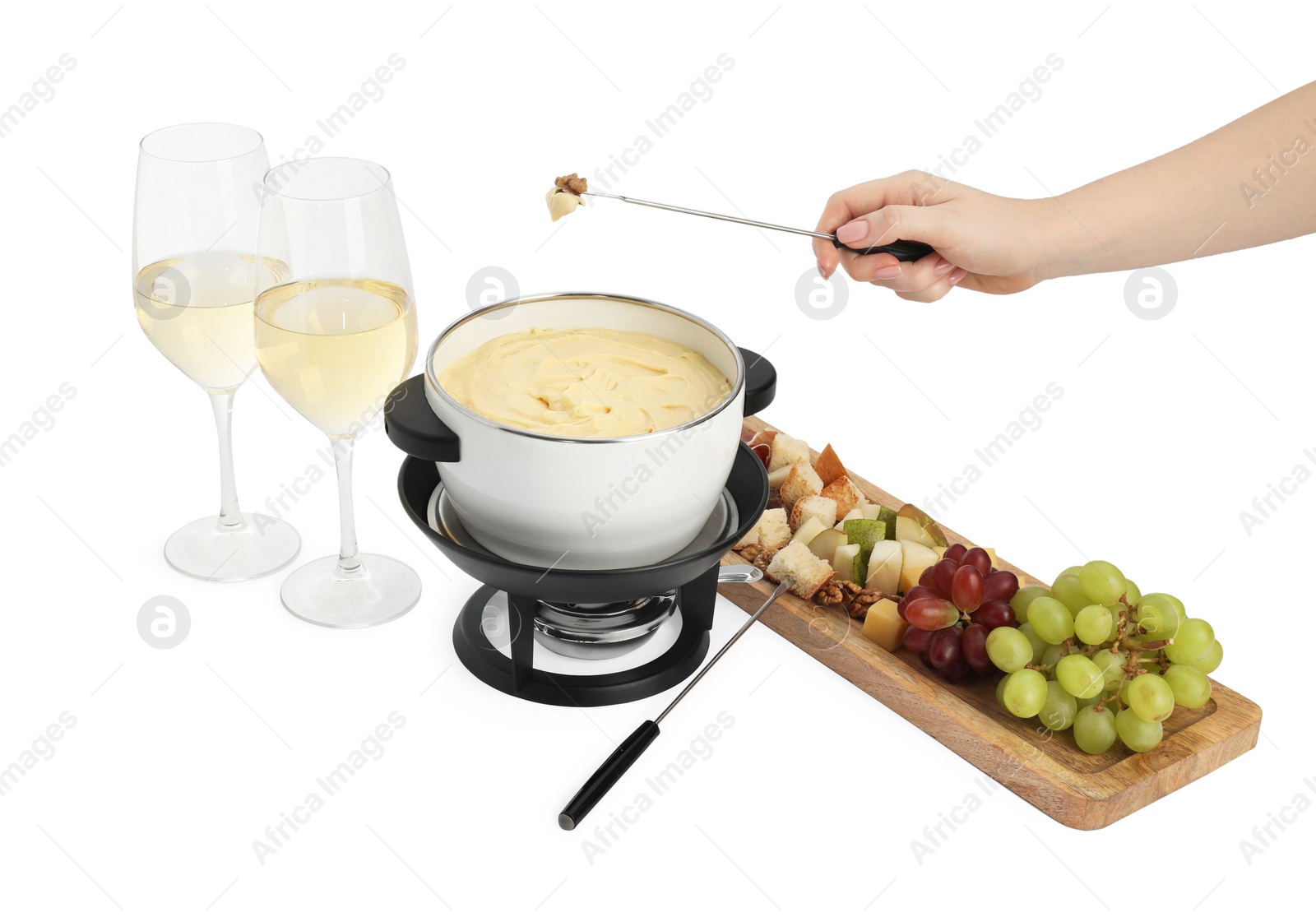 Photo of Woman dipping walnut into fondue pot with melted cheese on white background, closeup