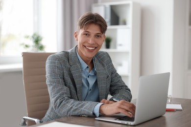 Man watching webinar at wooden table in office