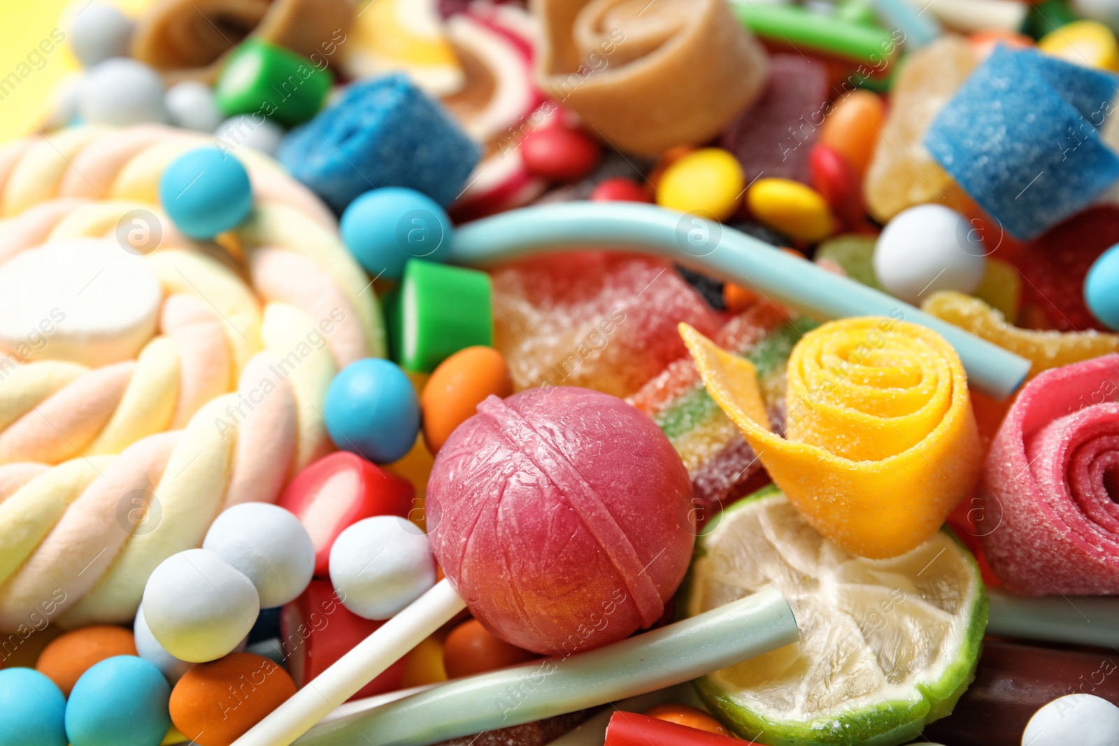 Photo of Many different yummy candies as background, closeup