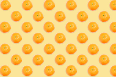 Pattern of tangerines on pale orange background