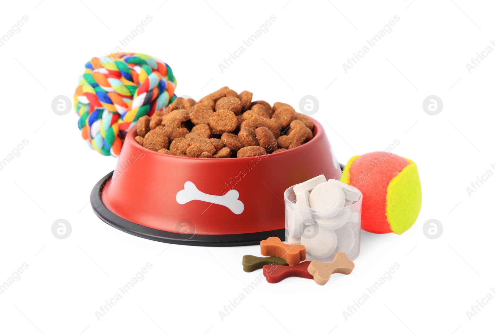 Photo of Dry pet food in bowl, vitamins and toys isolated on white