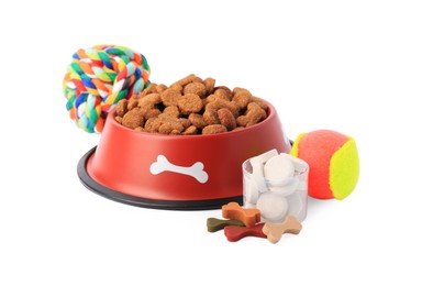 Photo of Dry pet food in bowl, vitamins and toys isolated on white