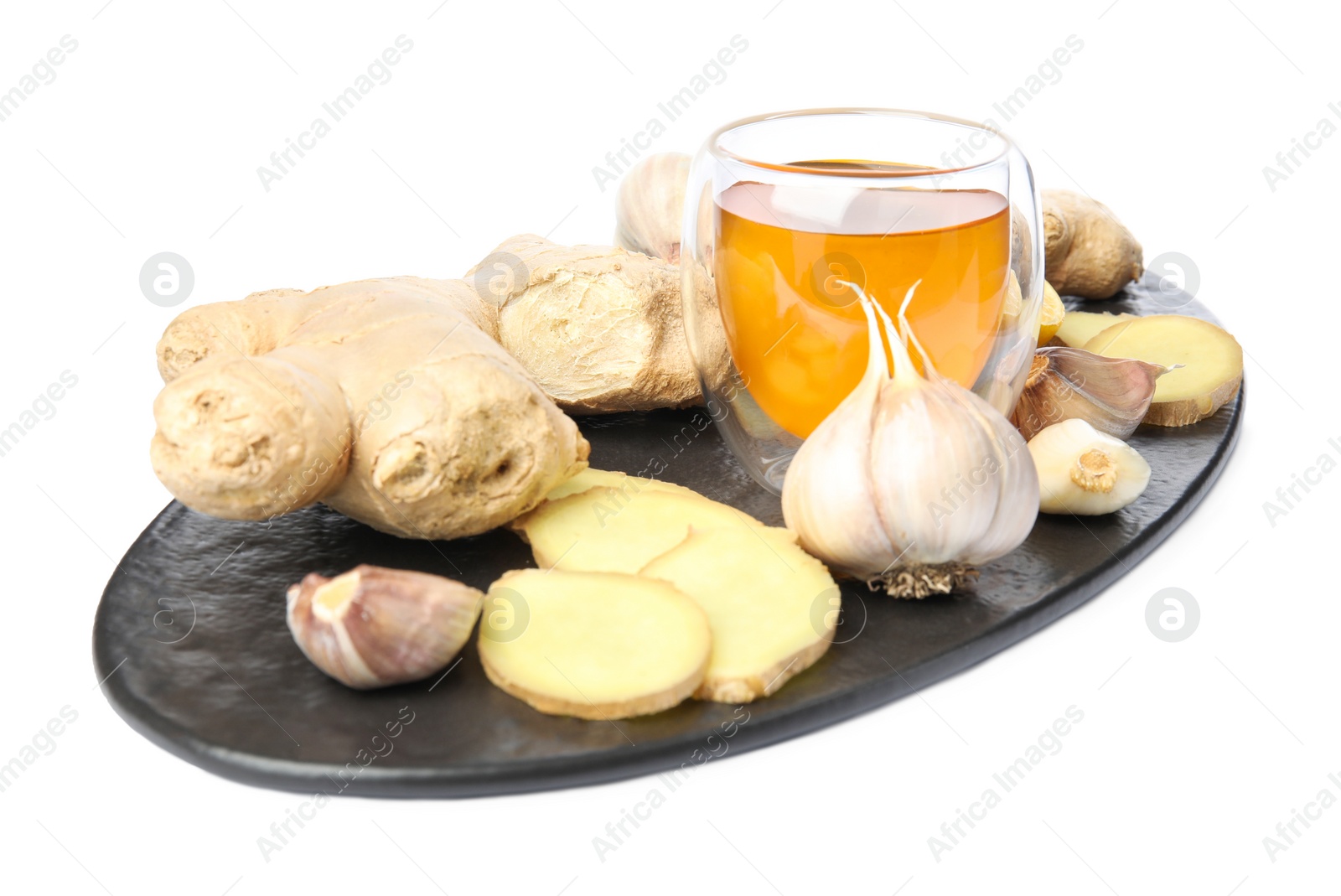 Photo of Fresh garlic and other natural cold remedies isolated on white