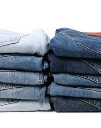 Image of Stacks of different folded jeans isolated on white