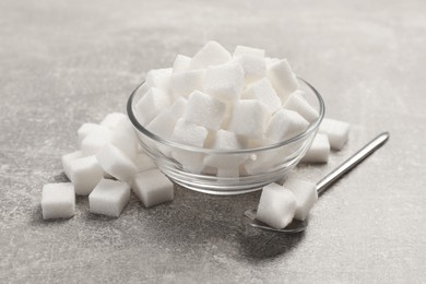 Photo of Bowl with sugar cubes served on grey table