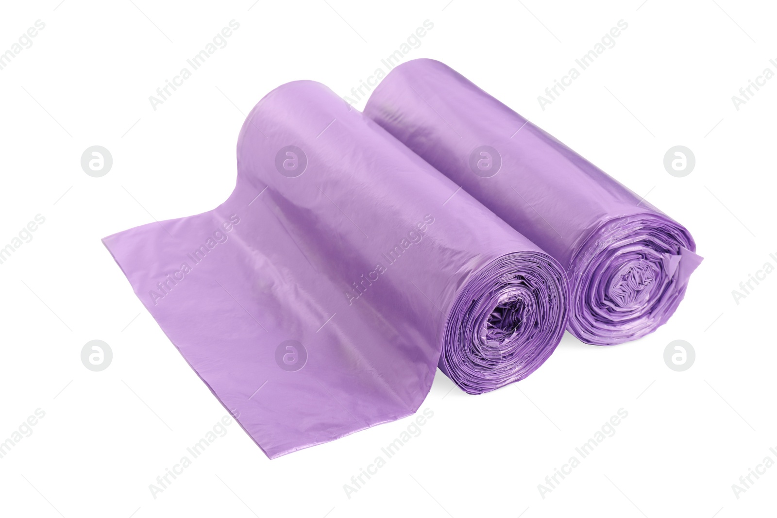 Photo of Rolls of violet garbage bags on white background. Cleaning supplies