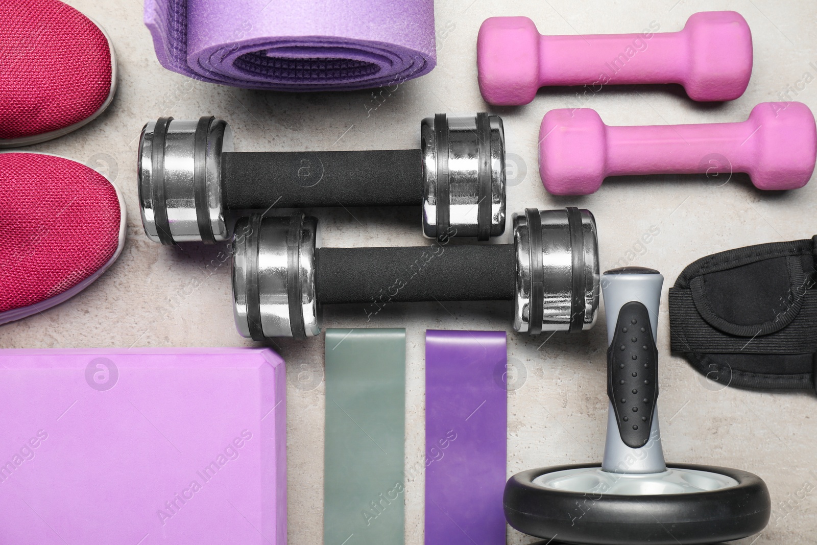 Photo of Different sports equipment on light grey table, flat lay