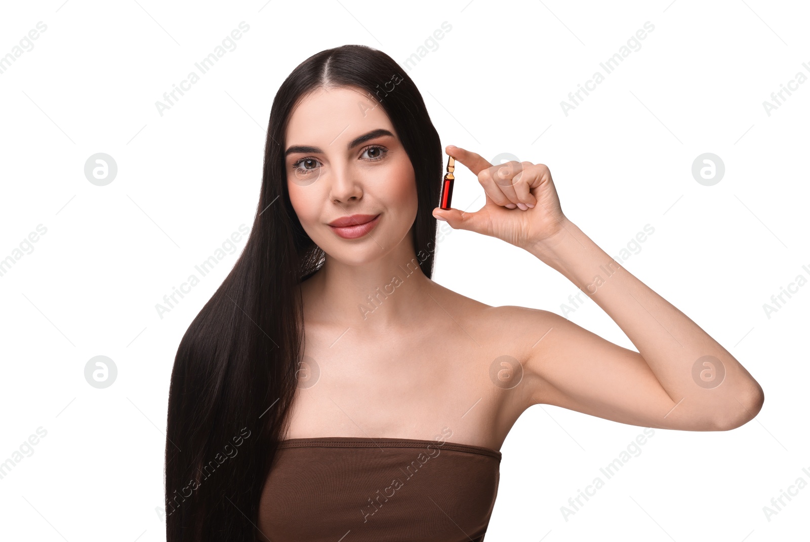 Photo of Beautiful young woman holding skincare ampoule on white background