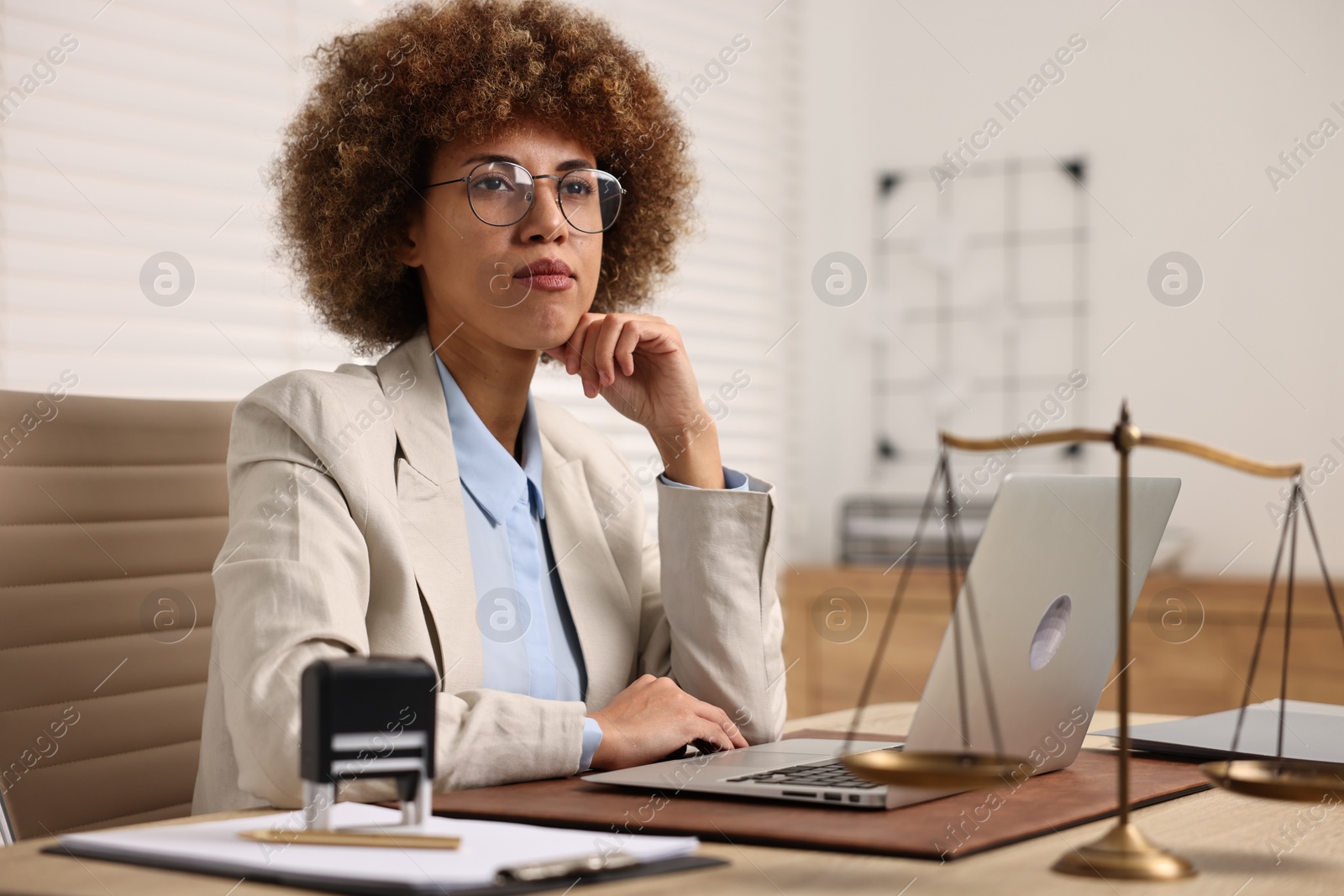 Photo of Notary with laptop at workplace in office