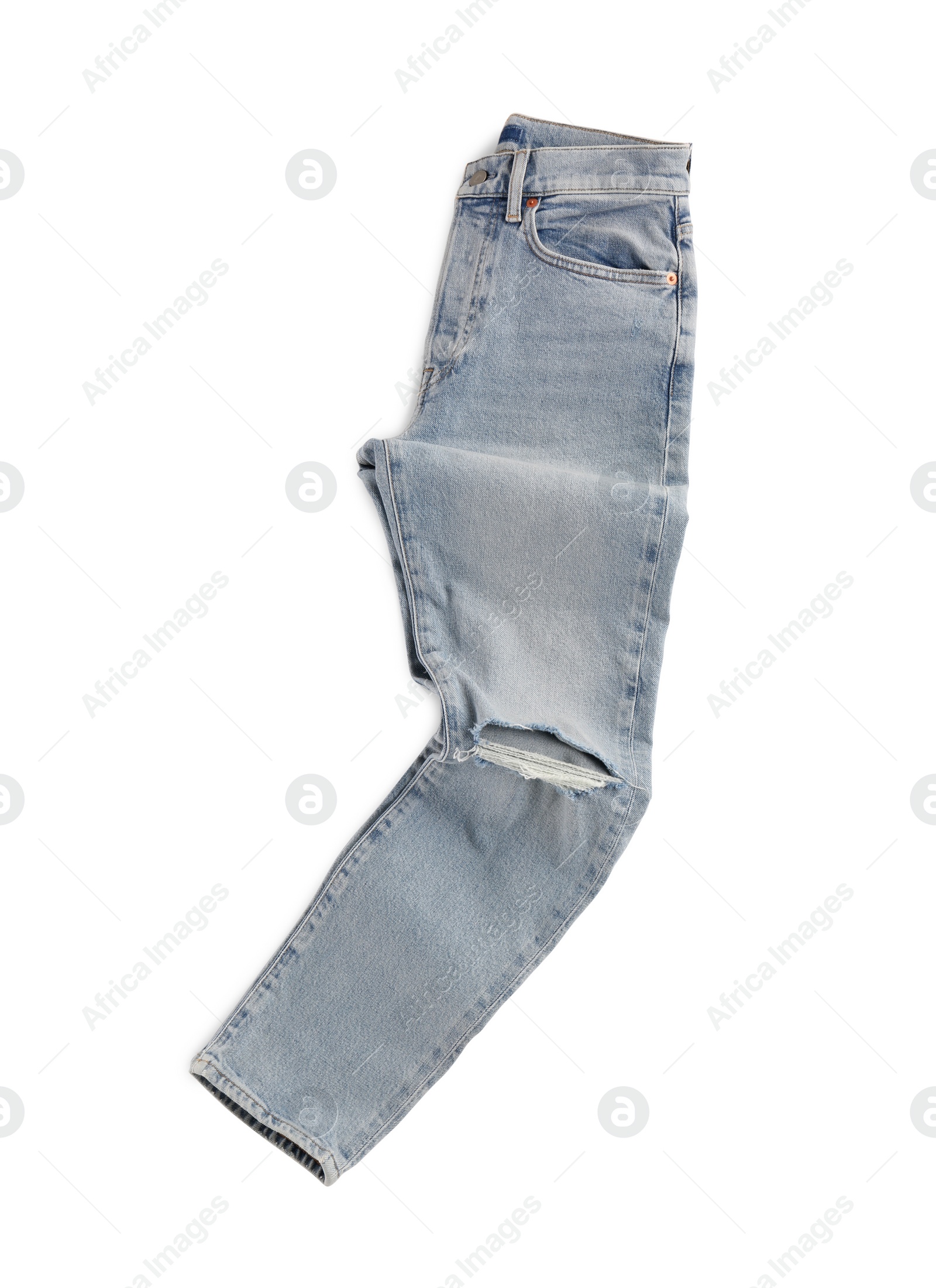 Photo of Rumpled light blue jeans isolated on white, top view. Stylish clothes