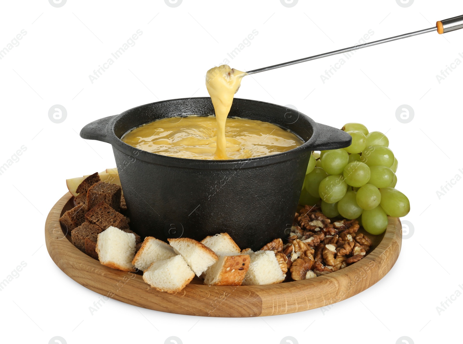 Photo of Dipping piece of bread into fondue pot with tasty melted cheese isolated on white