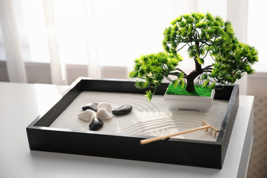 Beautiful miniature zen garden on white table indoors