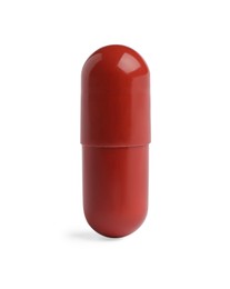 Photo of One red pill on white background. Medicinal treatment
