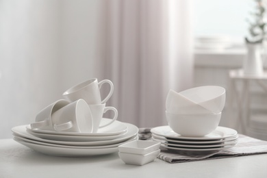 Photo of Setclean dishware on white table indoors