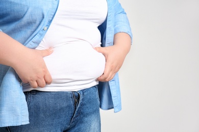 Photo of Overweight woman on light background