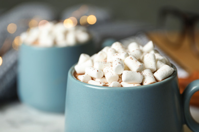 Photo of Delicious cocoa drink with marshmallows on table, closeup