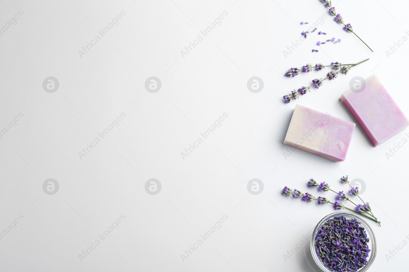 Photo of Composition with hand made soap bars and lavender flowers on white background, top view