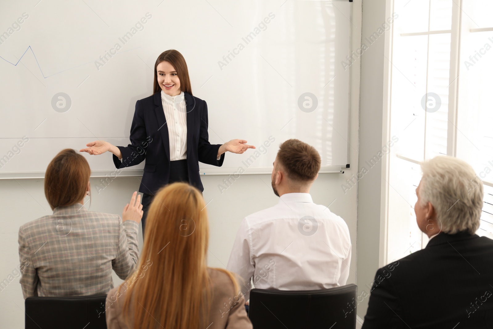 Photo of Professional business trainer working with people in office