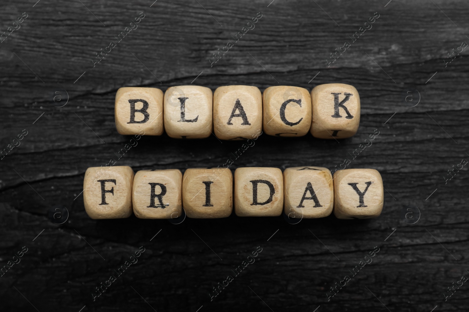 Photo of Words Black Friday made of cubes with letters on wooden table, flat lay