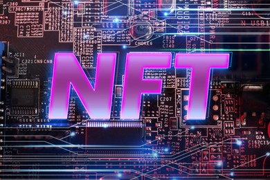 Image of Abbreviation NFT (non-fungible token) on computer motherboard, top view. Circuit board pattern illustration