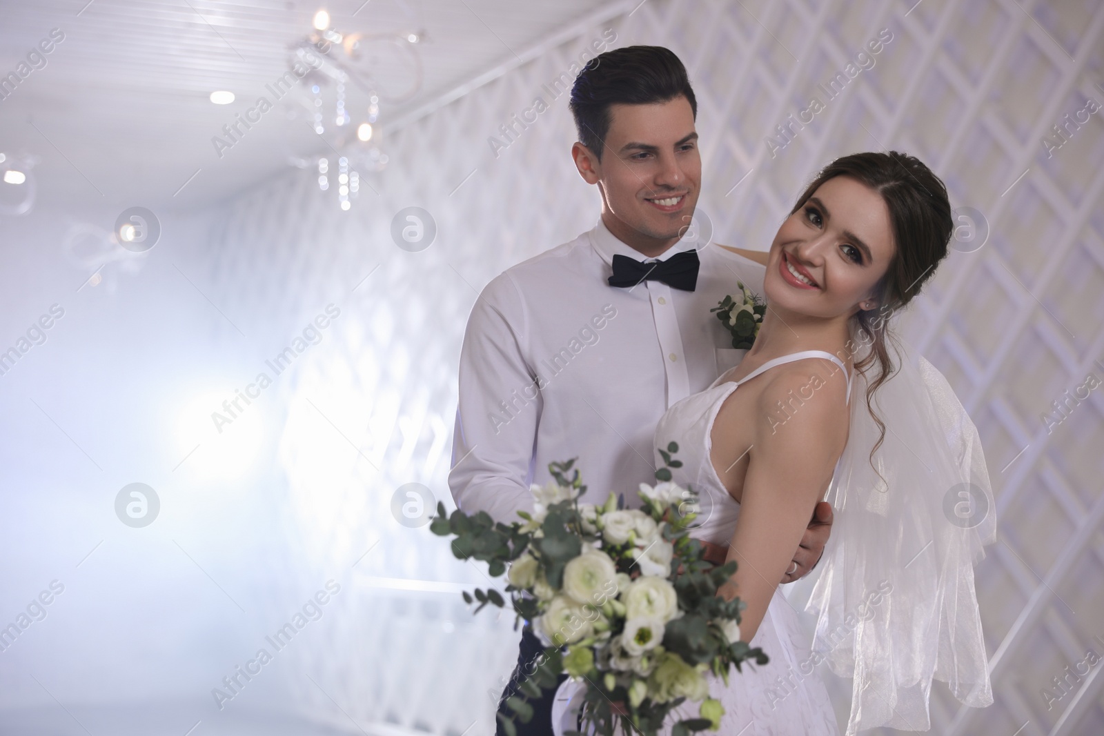 Photo of Happy newlywed couple dancing together in festive hall