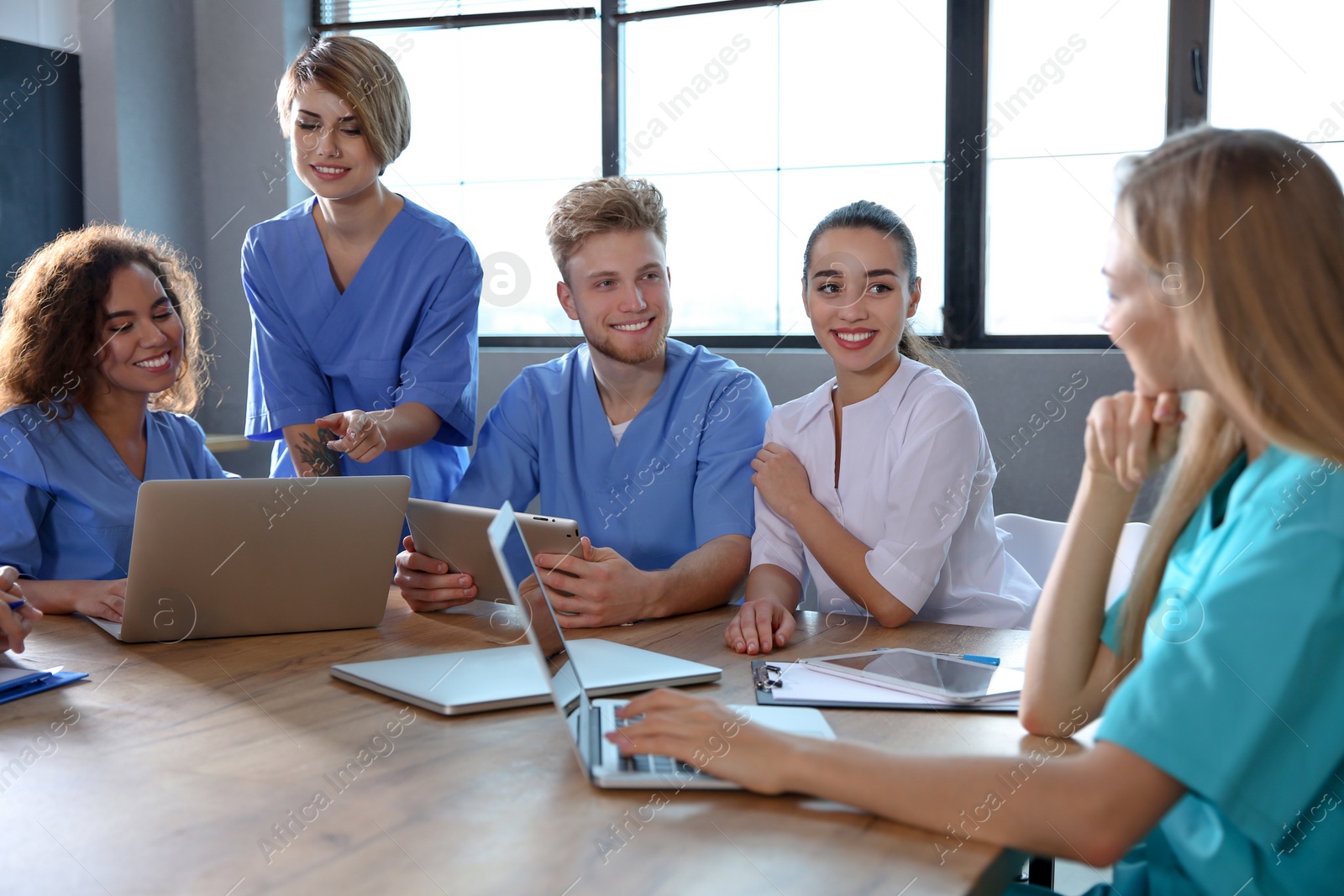 Photo of Group of smart medical students with gadgets in college