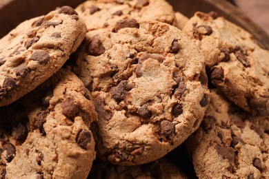 Photo of Many delicious chocolate chip cookies, closeup view