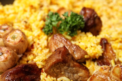 Delicious rice pilaf with meat as background, closeup