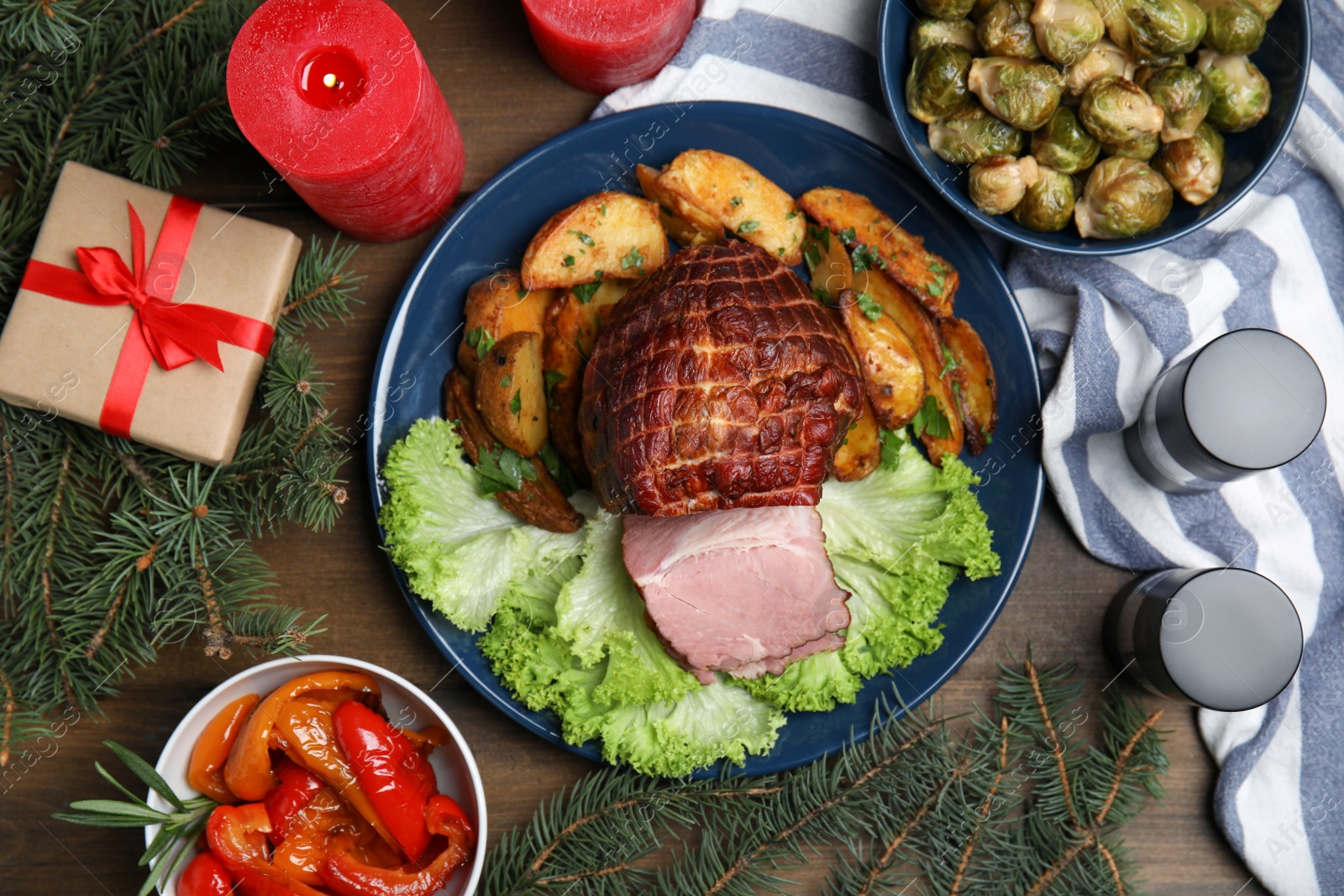 Photo of Flat lay composition with delicious ham and other festive dishes on wooden table. Christmas dinner