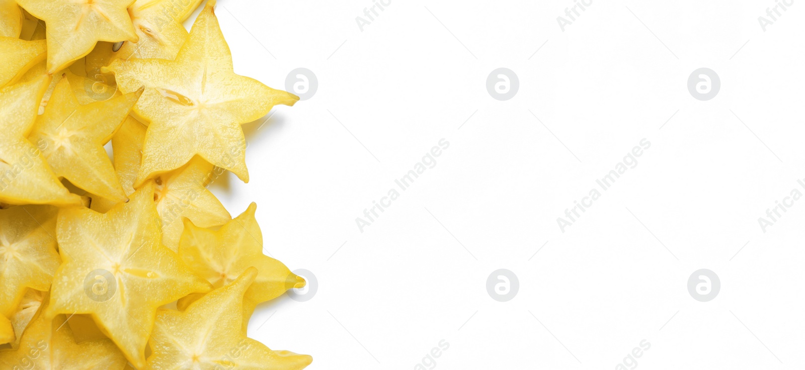 Photo of Pile of delicious carambola slices on white background, top view