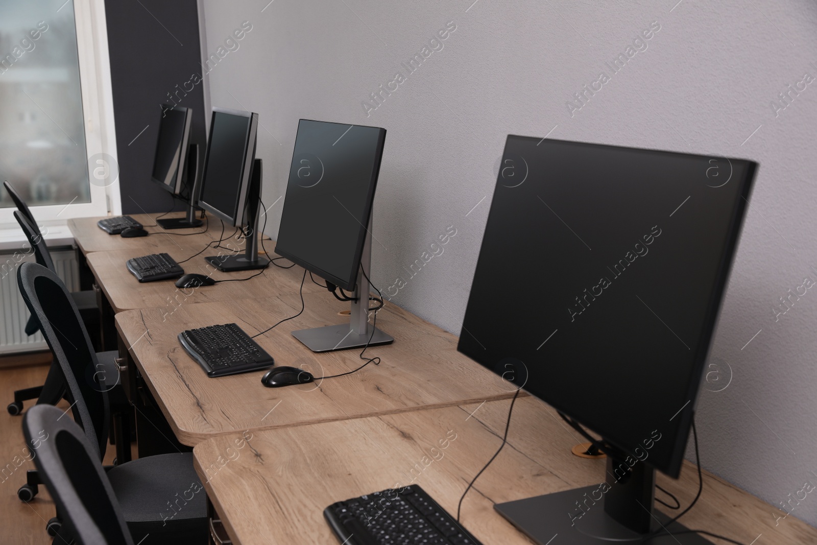 Photo of Many modern computers in open space office