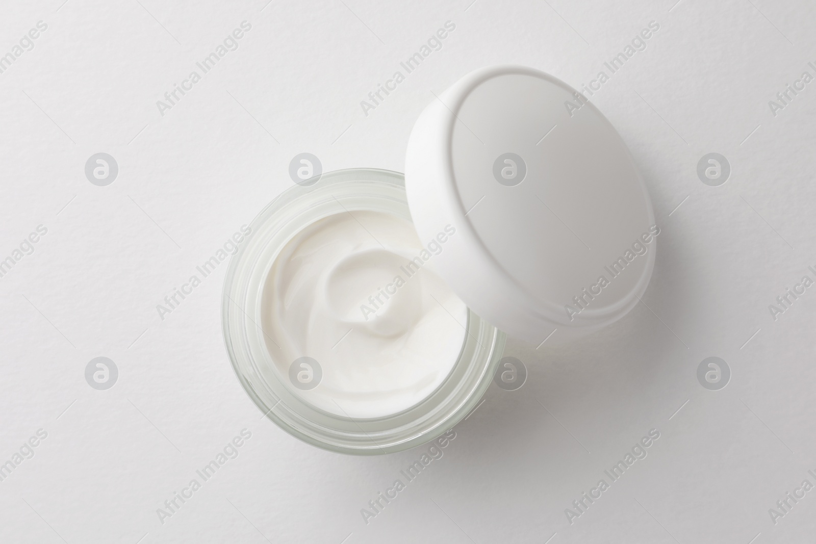 Photo of Jar of face cream on white background, top view