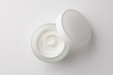 Photo of Jar of face cream on white background, top view