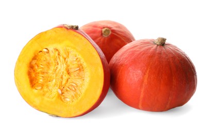 Many whole and cut ripe pumpkins on white background