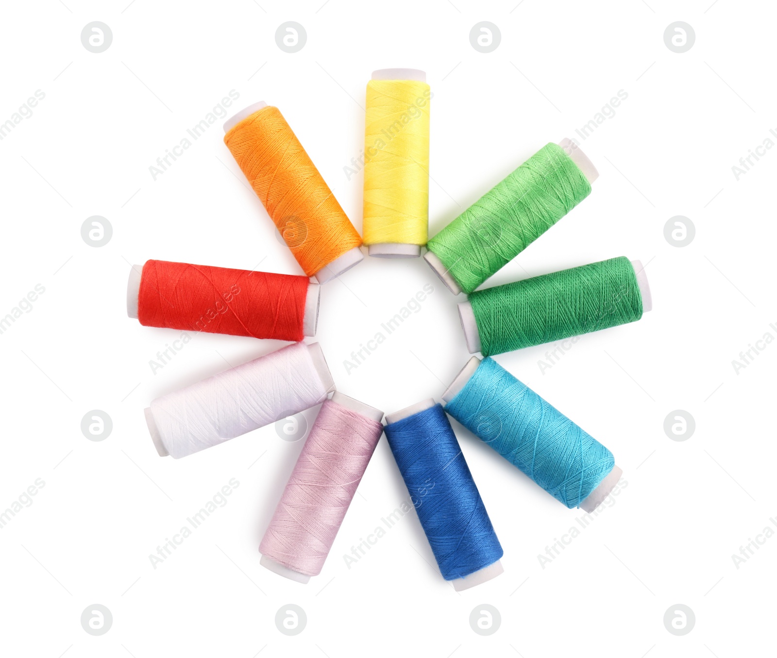 Photo of Set of colorful sewing threads on white background, top view