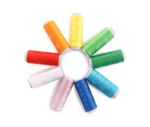 Set of colorful sewing threads on white background, top view