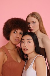 Portrait of beautiful young women on pink background