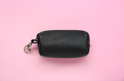 Photo of Stylish leather keys holder on pink background, top view