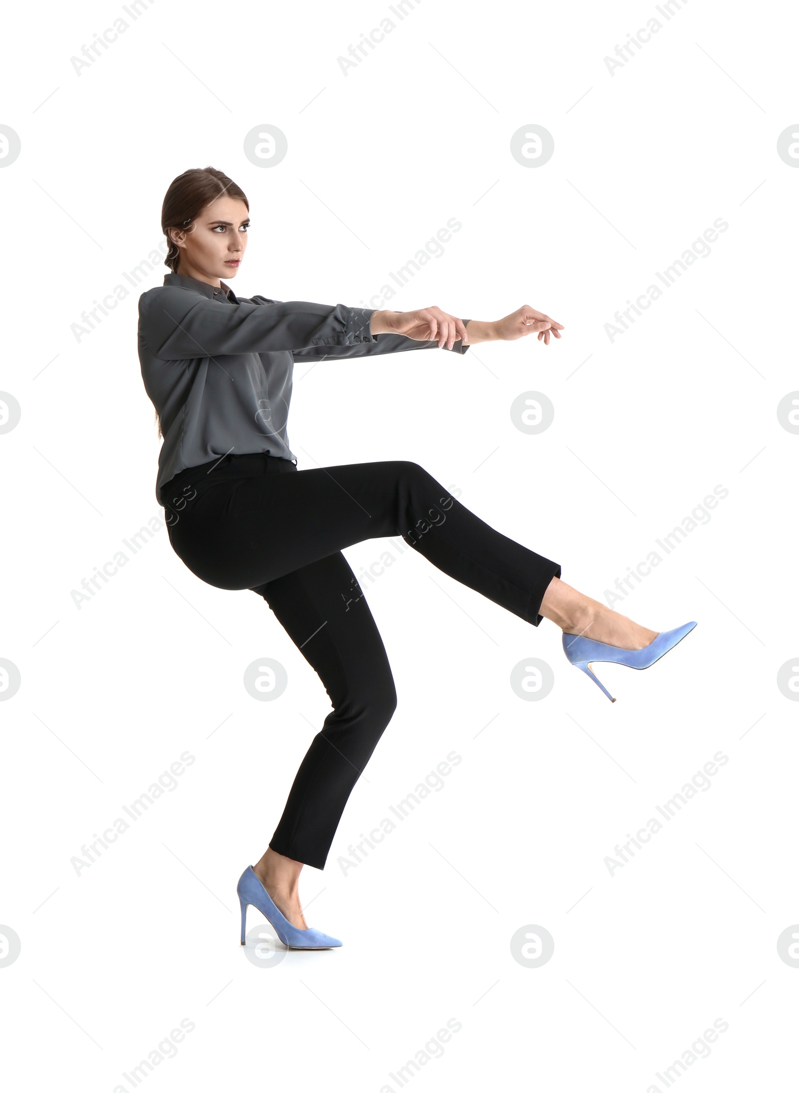 Photo of Young woman attracted to magnet on white background